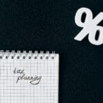 Notes z napisem tax planning i symbolem procenta na czarnym tle